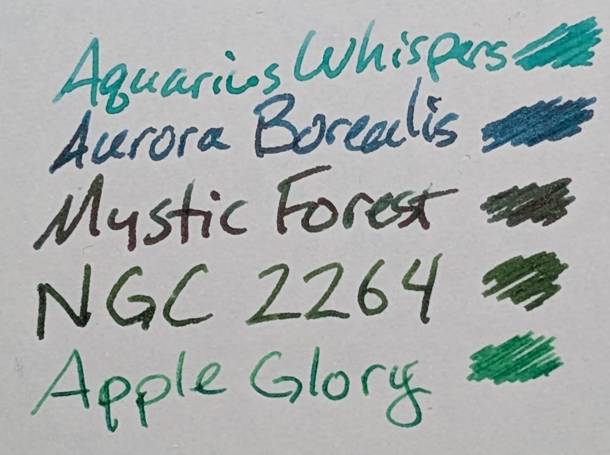 Photo of several inks on paper, the name of the ink is written followed by a little scribble of ink: - Aquarius Whispers - light-ish blue green - Aurora Borealis - dark-ish blue-green - Mystic Forest - a very dark green - NGC 2264 - a medium forest green - Apple Glory, a bright green
