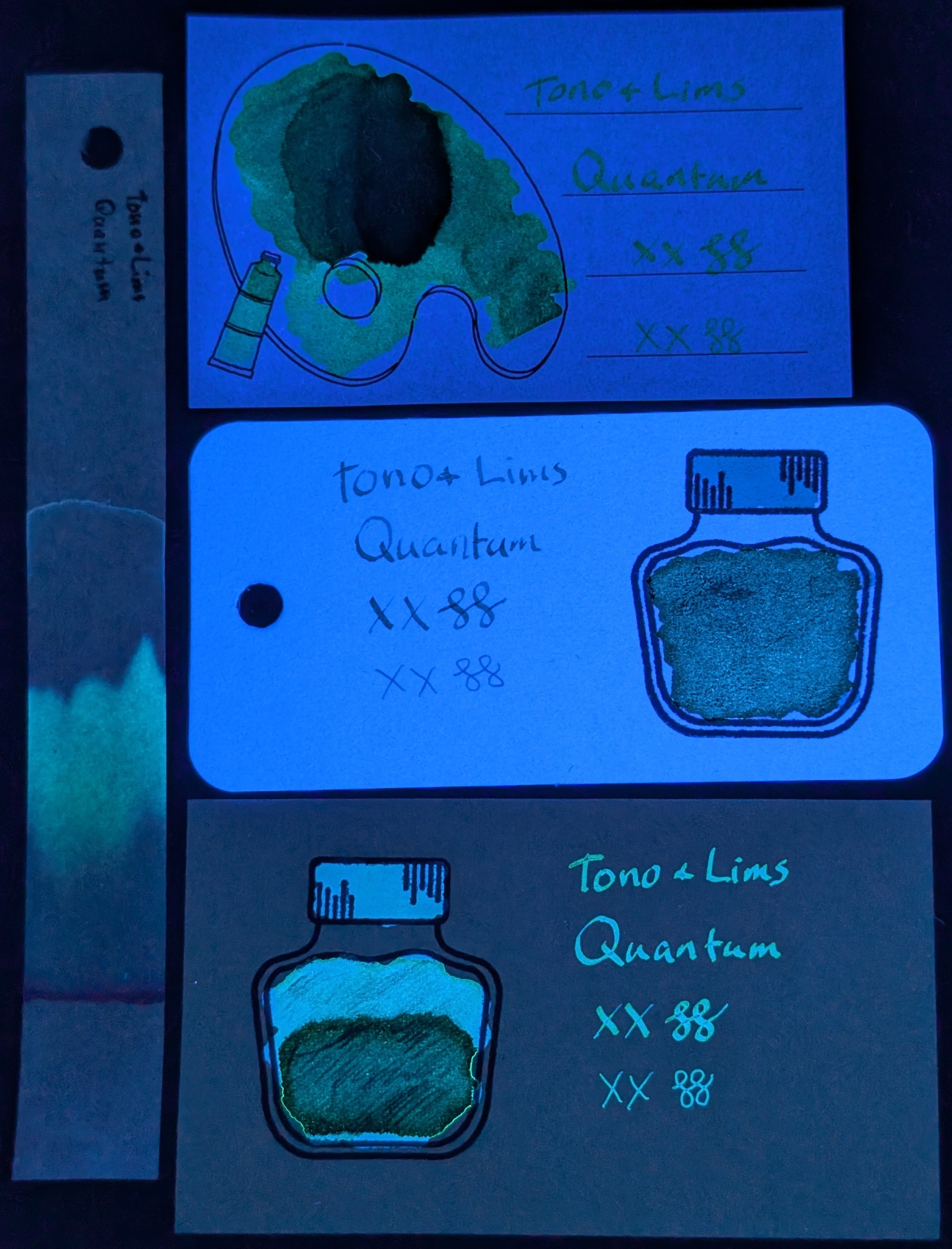 Same as the last photo but under primarily UV light. The Iroful paper is glowing and the ink swatch is glowing green. The col-o-ring paper is glowing very brightly and the ink in the bottle is glowing greenish, the cap is glowing light blue, and the text is glowing more blue. The Midori paper is not glowing, and the ink is glowing teal/greenish in the text and top of bottle, the bottle cap is more blue, while the bottom of the bottle is glowing even more teal/green. The chromatography strip has a greenish glow extending far past the end of where the blue was in the previous photo, and a slight halo of light blue going even farther than the green.