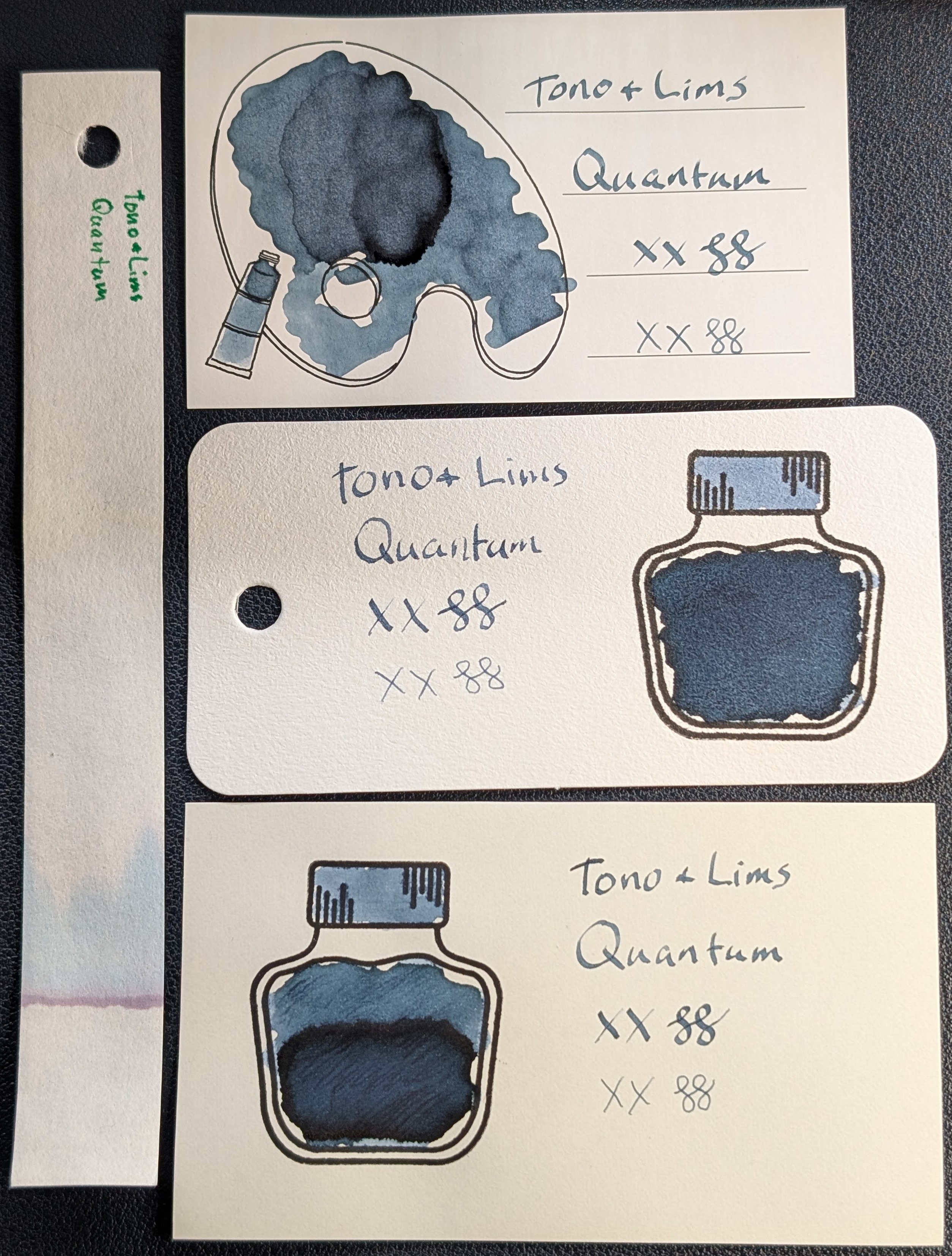 Photo of 3 ink swatches & chromatography strip for Tono & Lims Quantum which is a medium slate blue-leaning teal fluorescent colored ink with some shading. Each swatch contains the ink name followed by "XX" 2 curlicues in both stub and EF widths. Swatch 1: Iroful swatch card with an outline of a paint palette and tube. The palette is mostly filled in with swirls of ink and one area near the middle that is a bit darker and more blue. There is an outline of a paint tube which is swabbed and looks similar. The writing is readable and even with some shading on a few letters. Swatch 2: Col-o-ring swatch card with a stamped outline of an ink bottle. The outlined area is mostly full of an ink blob which is evenly dark slate blue and less green. Swab across "cap" is a pale slate blue. The writing sample is spotty in places, but also dark slate blue. Swatch 3: Midori MD swatch card with a stamped outline of an ink bottle. The outlined area is mostly full of an ink blob which is lighter in the top half and darker in the bottom half. Swab across "cap" is lighter like the top of the bottle. Text is similar to Iroful but darker. Chromatography starts with a purple line and quickly fades to light blue and then to nothing.