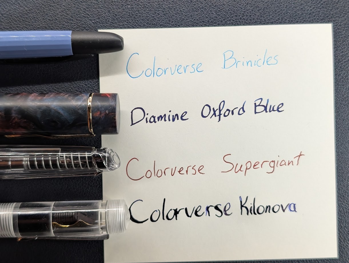 Photo of four writing samples on a piece of paper and the tips of four fountain pens next to each sample. From top to bottom they are: - Majohn A2, blue pen with black tip, writing sample says "Colorverse Brinicles" in light blue ink. - Asvine C2000, blue/red marbled pen, writing sample says "Diamine Oxford Blue" in very dark blue ink - Endless Phantom, clear capless pen, writing sample says "Colorverse Supergiant" in red ink - FPR Jaipur v2, clear pen with a flex nib, writing sample says "Colorverse Kilonova" in blue ink.