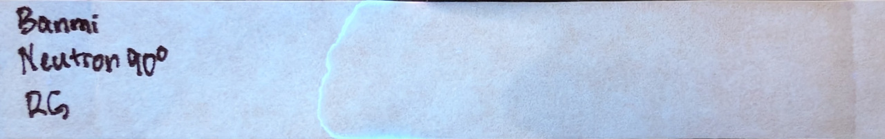Photo of chromatography paper under UV light.