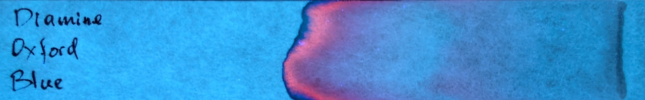 Photo of chromatography paper under UV light.