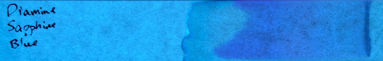 Photo of chromatography paper under UV light.