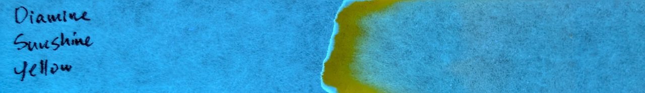 Photo of chromatography paper under UV light.
