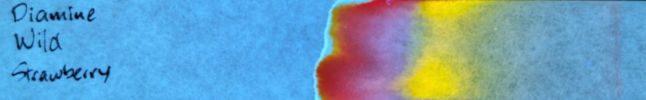 Photo of chromatography paper under UV light.