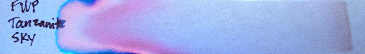 Photo of chromatography paper under UV light.