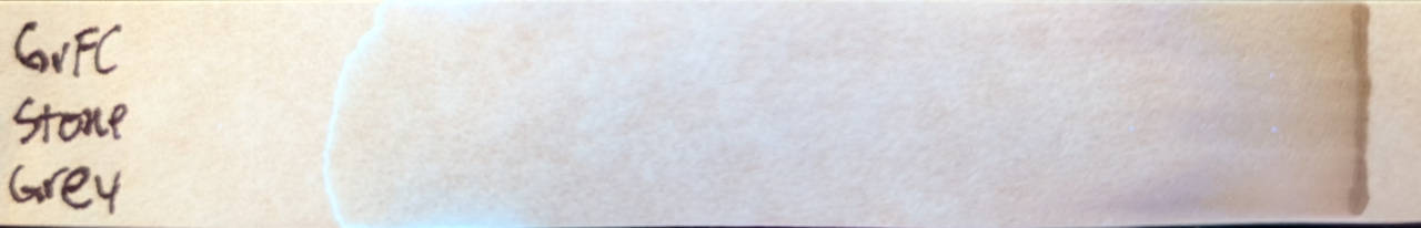 Photo of chromatography paper under UV light.