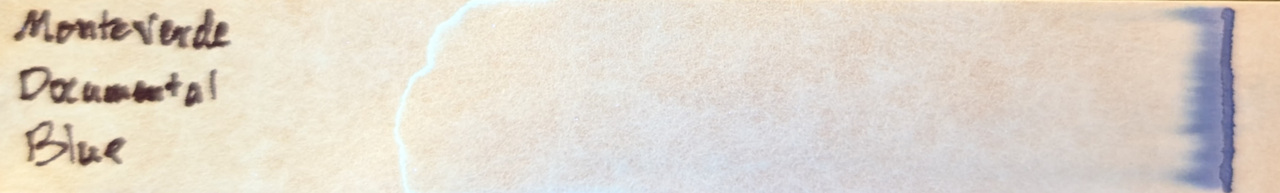 Photo of chromatography paper under UV light.