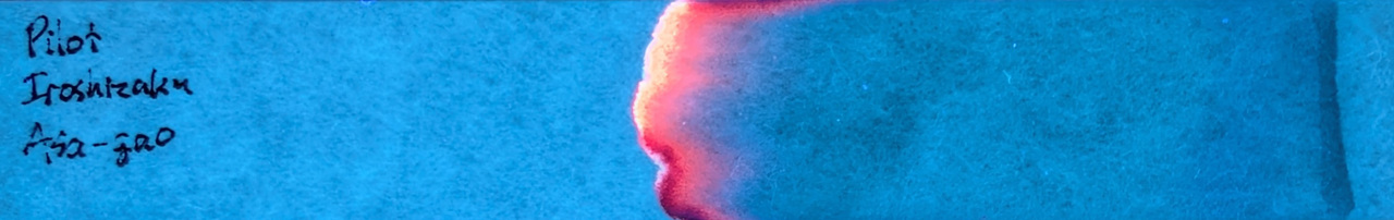Photo of chromatography paper under UV light.
