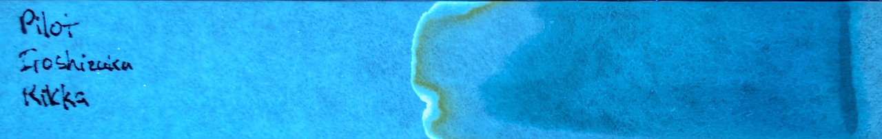 Photo of chromatography paper under UV light.