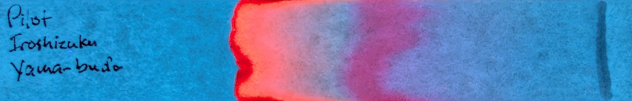 Photo of chromatography paper under UV light.