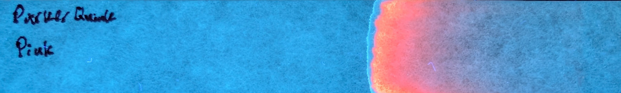 Photo of chromatography paper under UV light.