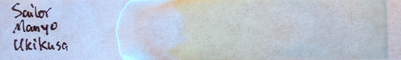 Photo of chromatography paper under UV light.