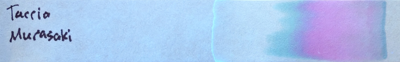 Photo of chromatography paper under UV light.