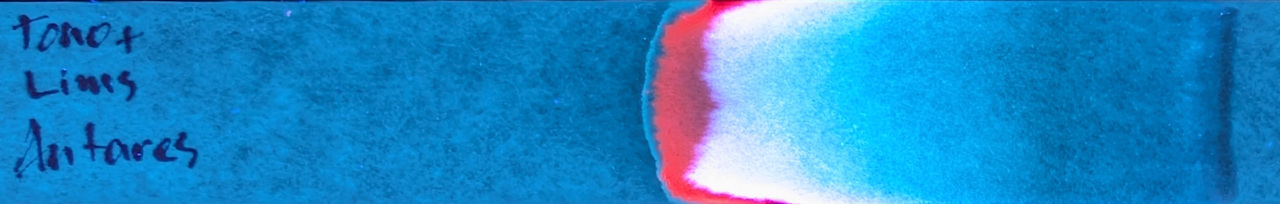 Photo of chromatography paper under UV light.