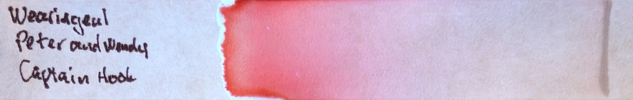Photo of chromatography paper under UV light.